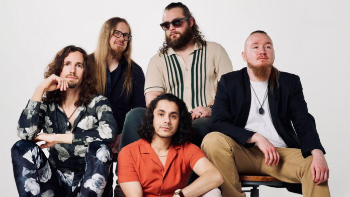 The Midnight Purchase The Midnight Purchase band portrait featuring Orlando Peña and members seated in a studio setting, showcasing the Milwaukee-based soul-folk and Americana group.