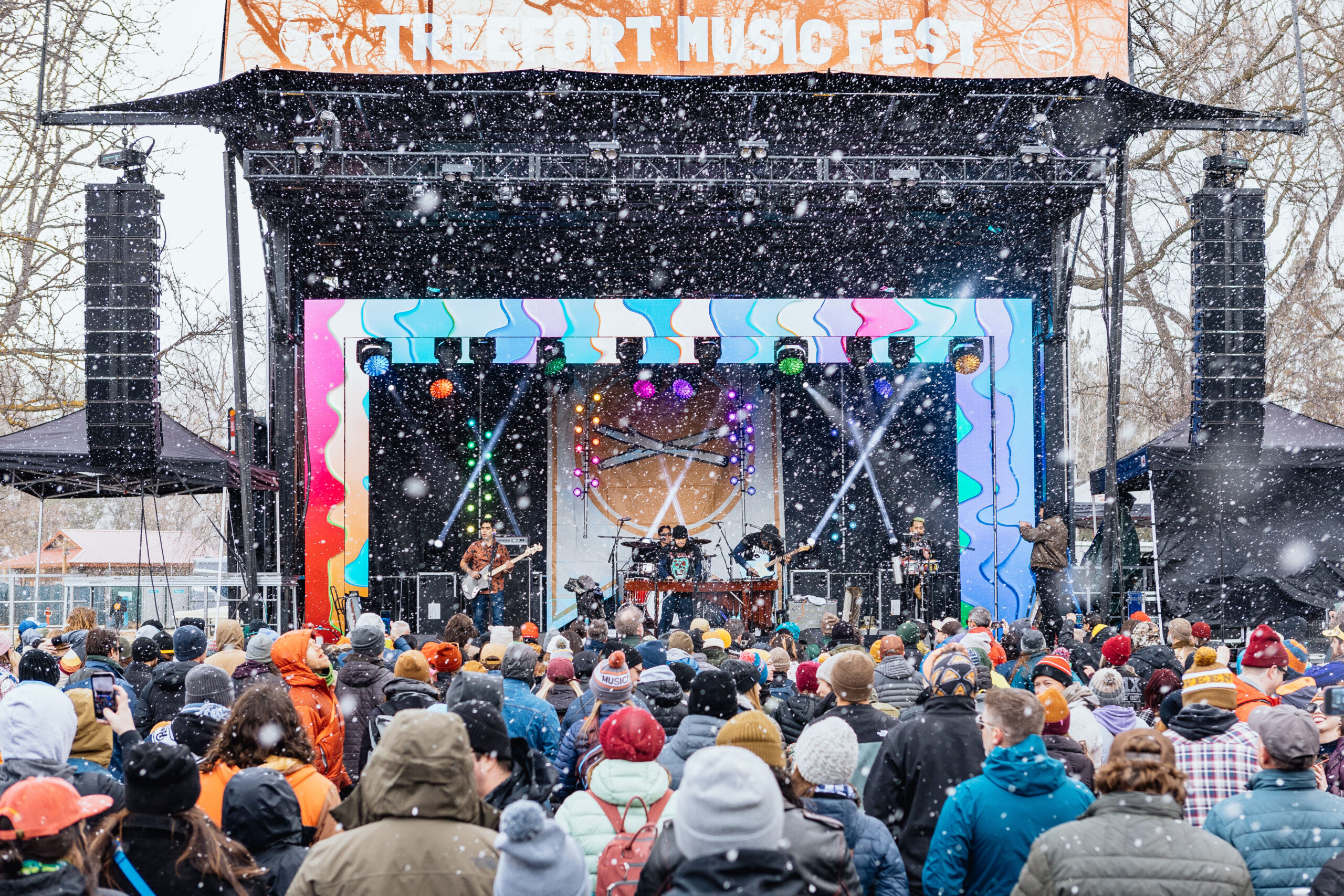 Crowd watching live band perform on Treefort Music Fest Main Stage in downtown Boise during confetti fall.