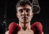 Elias Rivas on Boxing Nationals, Discipline, and Becoming More Than a Fighter Elias Rivas, an amateur boxer and USA Boxing prospect, poses with red hand wraps in a boxing gym ahead of his national boxing tournament appearance.