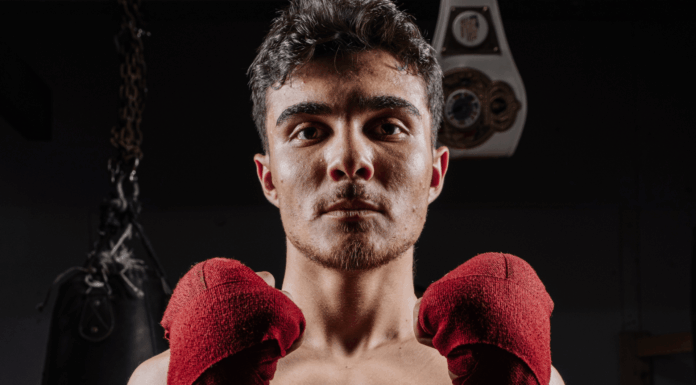 Elias Rivas on Boxing Nationals, Discipline, and Becoming More Than a Fighter Elias Rivas, an amateur boxer and USA Boxing prospect, poses with red hand wraps in a boxing gym ahead of his national boxing tournament appearance.