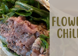 Rebel French Dip wrap with steak and arugula at Flower Child in Meridian, Idaho, beside “Flower Child” text.